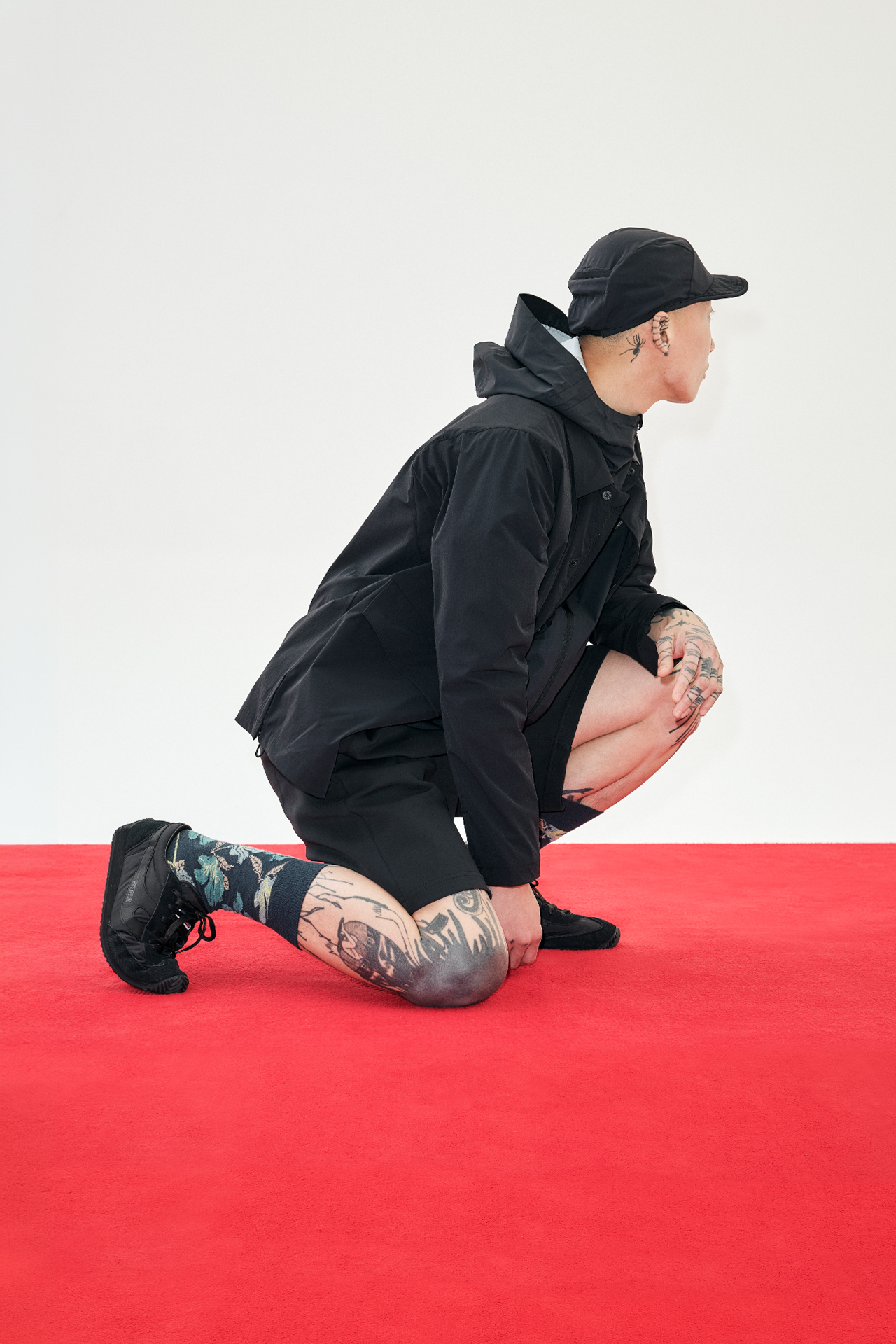 레드 바닥 위에서 한쪽 무릎을 꿇은 비키의 측면 컷